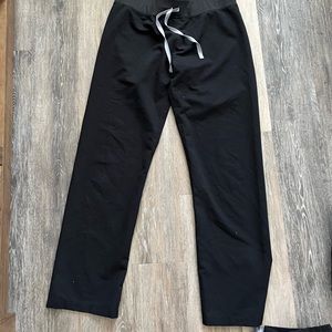 Four pairs of Figs black scrubs size M. One pair of joggers, 3 straight leg
